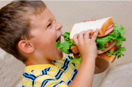Boy Eating Huge Sandwich — Image by © Dean Muz/Design Pics/Corbis