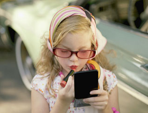 Young girl applying lipstick — Image by © Angela Coppola/Solus-Veer/Corbis