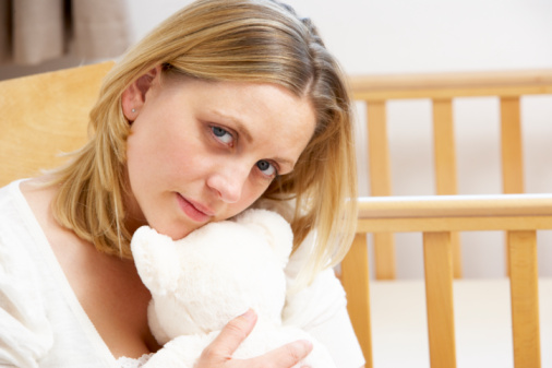 Sad Mother Sitting In Empty Nursery