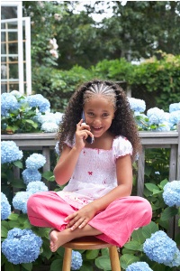 Portrait of a girl using a mobile phone in a garden