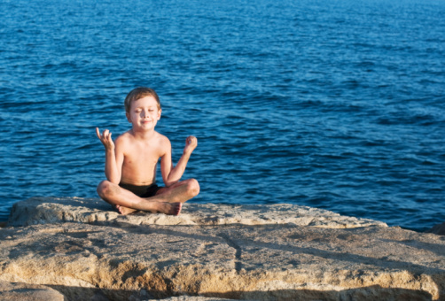 young boy meditating