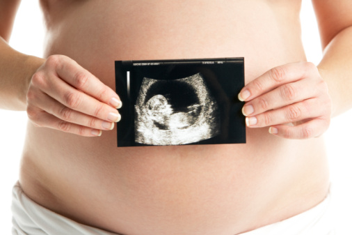 Detail Of Pregnant Woman Holding Ultrasound Scan