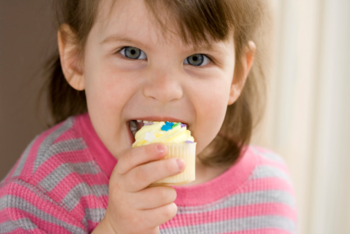 girl enjoying cupcake